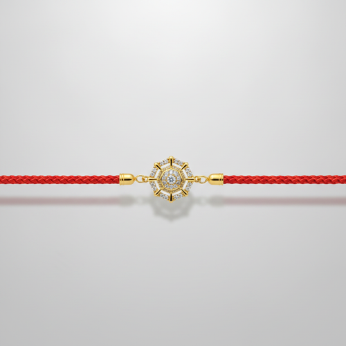 Elegant Diamond-Studded Gold Rakhi with Red Thread